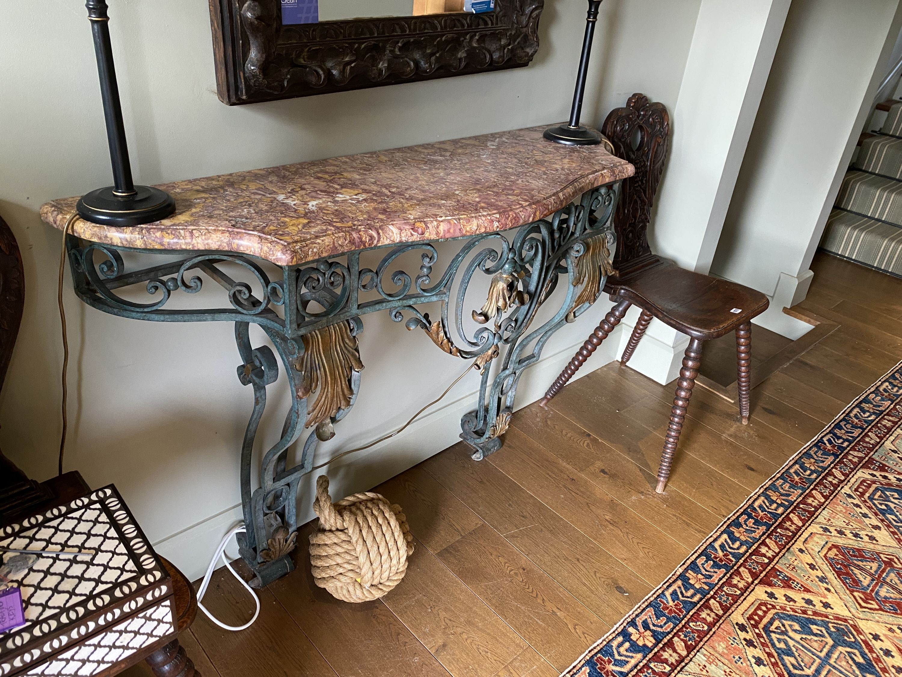 A French painted and gilt wrought iron console table, with serpentine marble top, width 132cm depth 40cm height 94cm